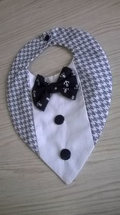 a bib with a black bow tie on it and a white collared shirt