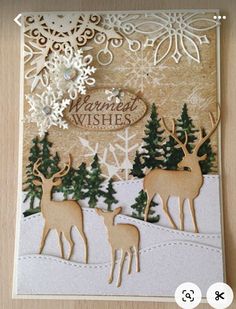 a handmade christmas card with reindeers and snowflakes on the bottom, which reads merry wishes