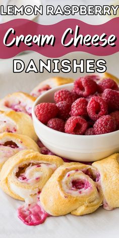 raspberry cream cheese danishes on a white plate with a bowl of raspberries