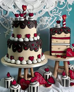 two tiered cakes and cupcakes with hearts on them