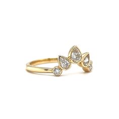 a yellow gold ring with three pear shaped diamonds