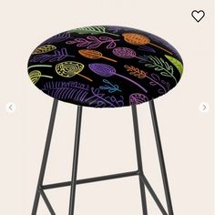 a stool with an artistically designed seat cover on it's back and legs