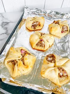 several pastries sitting on top of aluminum foil