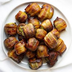 a white plate topped with bacon wrapped bananas