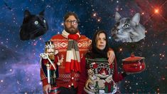 a man and woman standing in front of a space background with cats on their heads