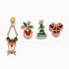 three christmas brooches are shown on a white surface, one is red and the other is green