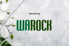 the word warock surrounded by stones and leaves on a white background with green lettering