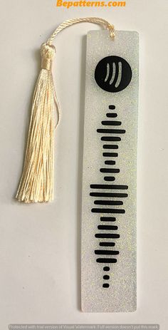 a bookmark with a tassel hanging from it