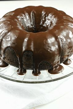 a chocolate bundt cake on a glass plate