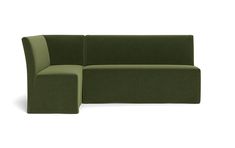 a green couch sitting on top of a white floor