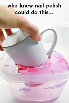 a person pours liquid into a plastic container with a white cup in it and another hand is holding the lid