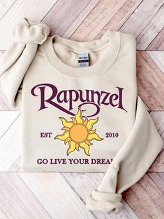 a white sweatshirt with the words rapunzel on it