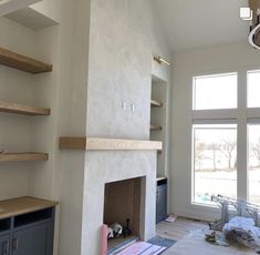 a living room filled with furniture and a fire place in the middle of a room