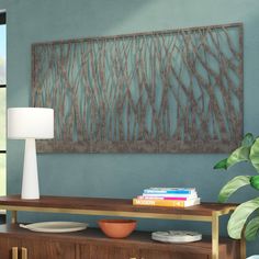 a living room scene with focus on the coffee table and wall art hanging above it