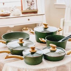 green pots and pans sitting on top of a table