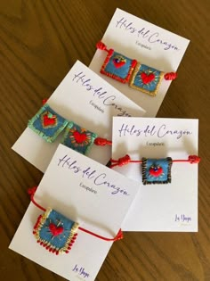 four cards with different designs on them sitting on a table