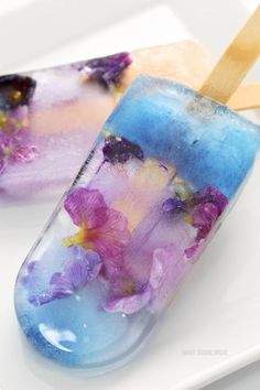 two popsicles with purple flowers on them