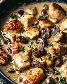 chicken and mushroom stew in a black bowl