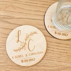 personalized wooden coasters with names and date engraved on the front, sitting on a table