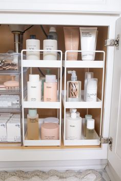 the inside of a bathroom cabinet filled with beauty products