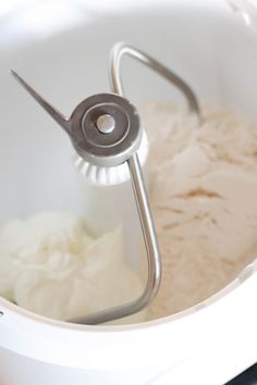 a mixer filled with white batter in a bowl