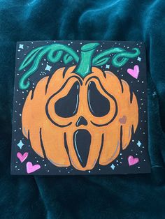 an orange pumpkin with its mouth open on a blue blanket that says you're too