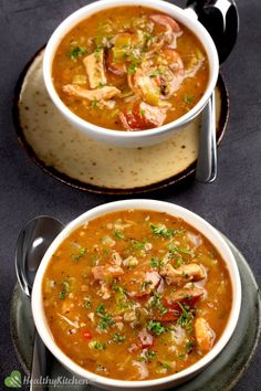 two bowls filled with soup on top of a table