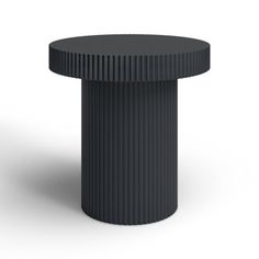 a black round table sitting on top of a white floor