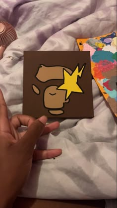 someone is holding up a card with an image of a monkey and star on it