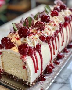 a cheesecake with cherries and whipped cream