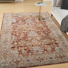 a living room scene with focus on the area rugs and the couch in the background