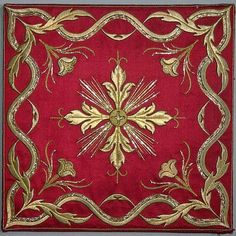 a red and gold square rug with an ornate design