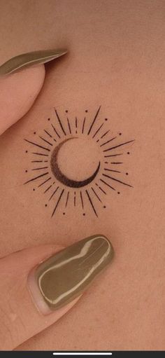 a woman's stomach with a small sun tattoo on her belly and an arrow in the middle