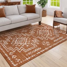 a living room with a couch, chair and rug