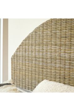 the headboard of a wicker bed frame