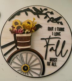 a sign that says, but i think i love fall most of all with flowers in a basket