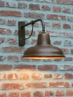 an old fashioned wall light against a brick wall