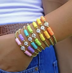 colorful bracelets are displayed on a woman's arm