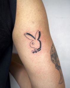 a tattoo on the arm of a person with a rabbit in it's head