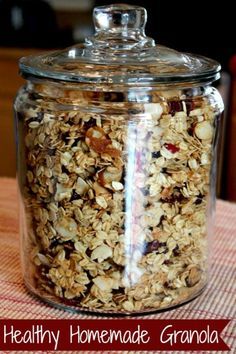 a glass jar filled with granola on top of a table