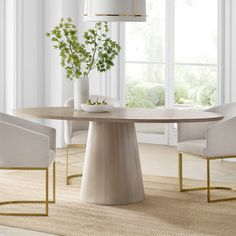 a dining room table with chairs and a vase on it in front of a window