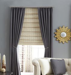 a living room with gray walls and curtains