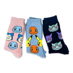 three pairs of socks with cartoon characters on them, one is blue and the other has pink