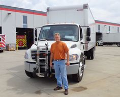 a man standing in front of a white truck