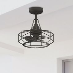 a ceiling fan that is attached to a light fixture in a room with white walls