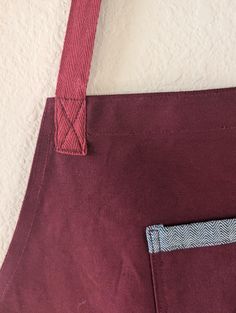 a red tote bag with a blue pocket