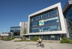 a person riding a bike in front of a building