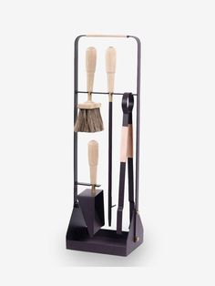 a set of three brushes sitting on top of a stand