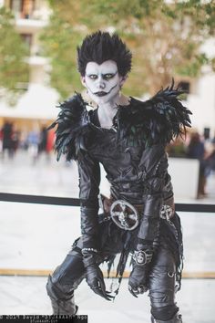 a man dressed up in black and white makeup