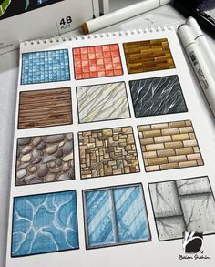 a drawing book with different colored tiles on it and some pens next to it,